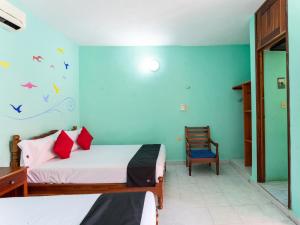 Säng eller sängar i ett rum på Hotel Hacienda Bacalar