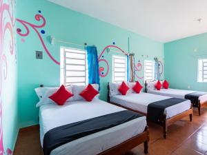 En eller flere senge i et værelse på Hotel Hacienda Bacalar