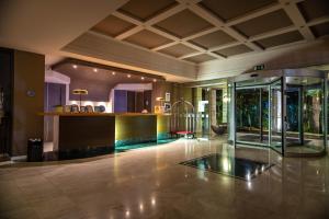 an empty lobby with a bar in a building at Dion Palace Resort and Spa in Limín Litochórou