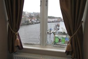 a window with a view of a river at The Dolphin in Whitby +26 photos
