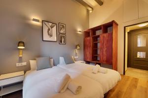 a bedroom with a large white bed with two pillows at Aqua Apartment by Olala Homes in Barcelona