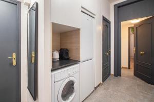 A kitchen or kitchenette at Aqua Apartment by Olala Homes