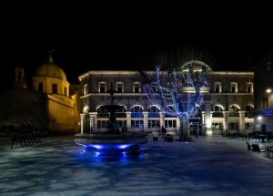 einen Brunnen vor einem Gebäude in der Nacht in der Unterkunft Cent Cinq - unique apartments in the heart of Apt in Apt