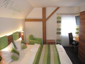 a hotel room with a bed and a cross on the wall at Burgschänke, Hotel & Restaurant - E-Mobilität Ladestationen für Elektroautos in Burgthann