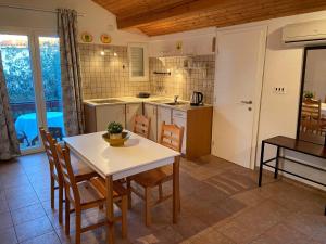 a kitchen and dining room with a table and chairs at Holiday Home Darko in Novalja