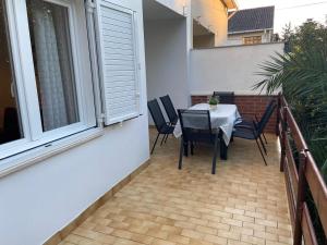 a patio with a table and chairs on a balcony at Holiday Home Darko in Novalja