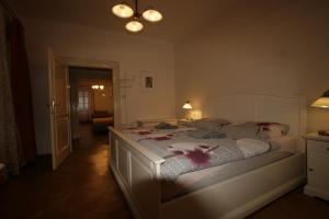 a bedroom with a white bed with flowers on it at Apartment No 0A Anenska 13 - Stare Mesto in Prague