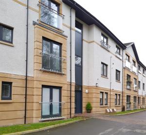 an apartment building with windows on a street at 23 Hedgefield House in Inverness