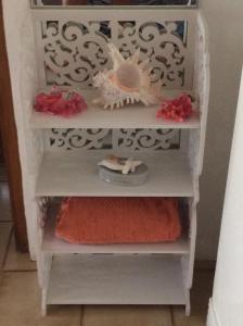 a set of three white shelves with towels on them at Vi Miles Lodge in Mahe