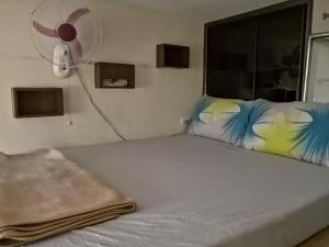 una camera con letto e ventilatore di H&M Management @ PalmTree Villas a Manila