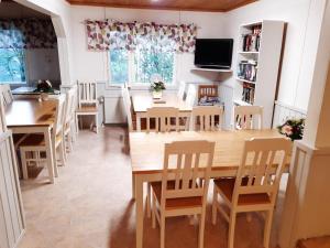 a dining room with a large wooden table and chairs at Matkakoti, Motel Kieppi Kuhmo in Kuhmo