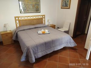 a bed with a tray of food on top of it at L'Albicocco in Ladispoli