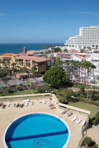 a large swimming pool next to a resort at Copacabana 8 in Playa Fañabe