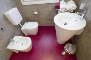 a bathroom with a white toilet and a sink at Casa Stucky in Udine