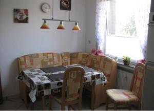 a table and chairs in a kitchen with a table and a table and chairsktop at Ferienwohnung Barbara in Hagenburg