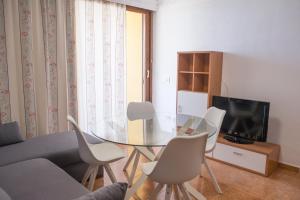a living room with a glass table and chairs at Copacabana 2 in Playa Fañabe