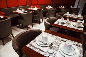 a row of tables and chairs in a restaurant at Arcadie Montparnasse in Paris