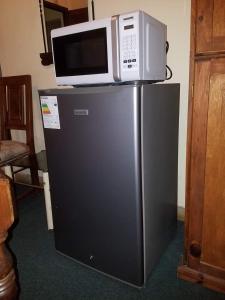 a microwave sitting on top of a refrigerator at Hotel Trinidad in Trinidad