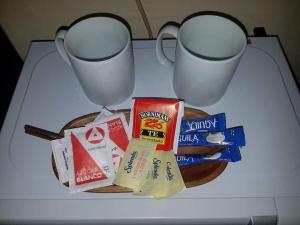 a table with two coffee cups and a plate of food at Hotel Trinidad in Trinidad