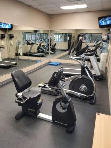 a gym with several exercise bikes in a room at Ramada by Wyndham North Platte in North Platte