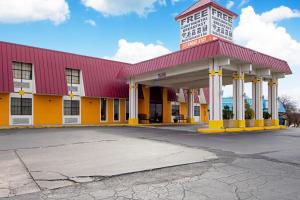 a red and yellow building with a clock tower at Economy Inn & Suites in Denton
