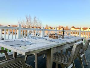 a wooden table with glasses and a bottle of wine at Hello !! and welcome to Solius Lodge in South Cerney