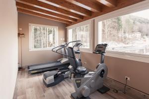 a room with a gym with a treadmill and windows at Albergo Capriolo in Sestola