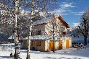 a house in the snow with snow covered trees at Gîte "Entre Champsaur et Valgodemard" in Saint-Jacques-en-Valgodemard