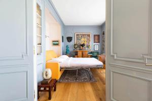a bedroom with a bed and a table in it at Veeve - Rooftop Views of the Arc de Triomphe in Paris