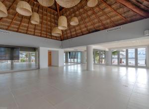 
a very large room with a lot of windows at Puerto Aventuras Hotel & Beach Club in Puerto Aventuras
