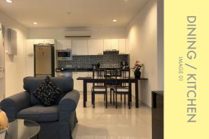 a kitchen and dining room with a table and chairs at Stylish Condo Stunning Views in Kamala Beach