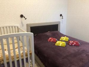 a bedroom with a bed with two cars on it at Karlsons apartment in Liepāja