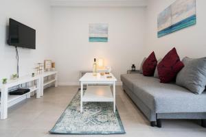 a living room with a couch and a tv at One Bedroom Seaview Urban Apartment Lagos in Lagos