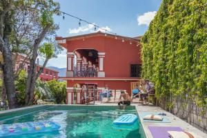 a house with a swimming pool in front of a house at Selina Antigua in Antigua Guatemala
