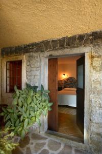 a door into a room with a bed in a bedroom at B&B Podere Bramapane in Montelungo Superiore