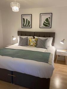 a bedroom with a large bed with white sheets and pillows at Womack Lodge in Saint Helens