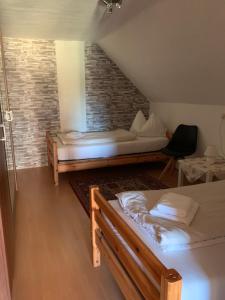 a attic room with two beds and a couch at Seerestaurant & Suiten Hayat in Steindorf am Ossiacher See