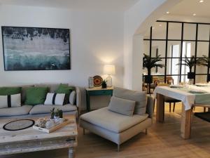 a living room with a couch and a table at Villa Bahía in Port de Pollensa