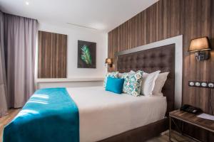 En eller flere senger på et rom på SBN Suite Hôtel