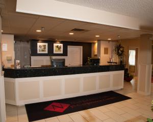 a lobby with a reception counter in a building at Northfield Inn Suites and Conference Center in Springfield