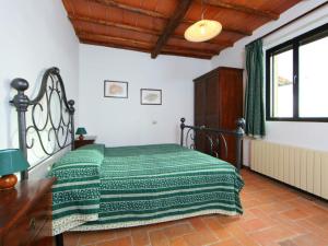 a bedroom with a bed with a green blanket on it at Staffolino in Siena +157 photos