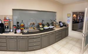 a kitchen with a counter with alot of food on it at Northfield Inn Suites and Conference Center in Springfield