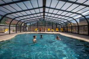 a group of people in a swimming pool at Les Prairies de la Mer - Baie de Somme in Favières +31 photos