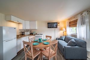 a kitchen and living room with a table and a couch at Ocean Glass Inn in Rehoboth Beach