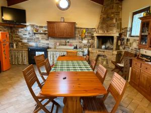 a large kitchen with a wooden table and chairs at Dependance con vista mare in Colonnella
