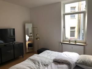 Ένα ή περισσότερα κρεβάτια σε δωμάτιο στο RÜ Business Apartments & Suites