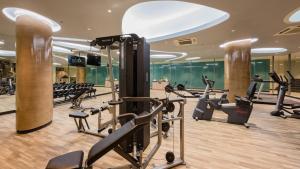 a gym with treadmills and ellipticals in a building at Oceanfront Beach Resort - SHA Extra Plus in Patong Beach
