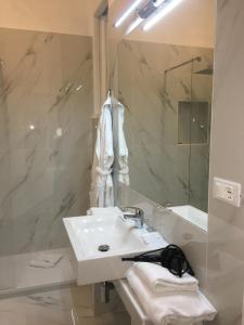 bagno bianco con lavandino e doccia di Affreschi Su Roma Luxury B&B a Roma