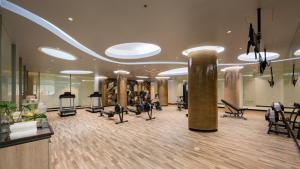 a gym with treadmills and exercise equipment in a building at Oceanfront Beach Resort - SHA Extra Plus in Patong Beach