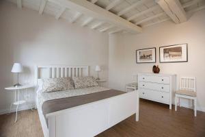 um quarto branco com uma cama branca e uma cómoda em Maffia Luxury em Florença